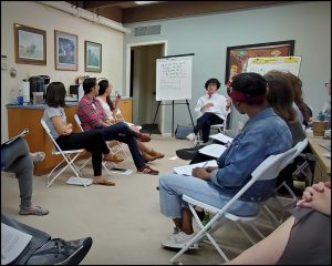 Small discussion group gathered on folding chairs