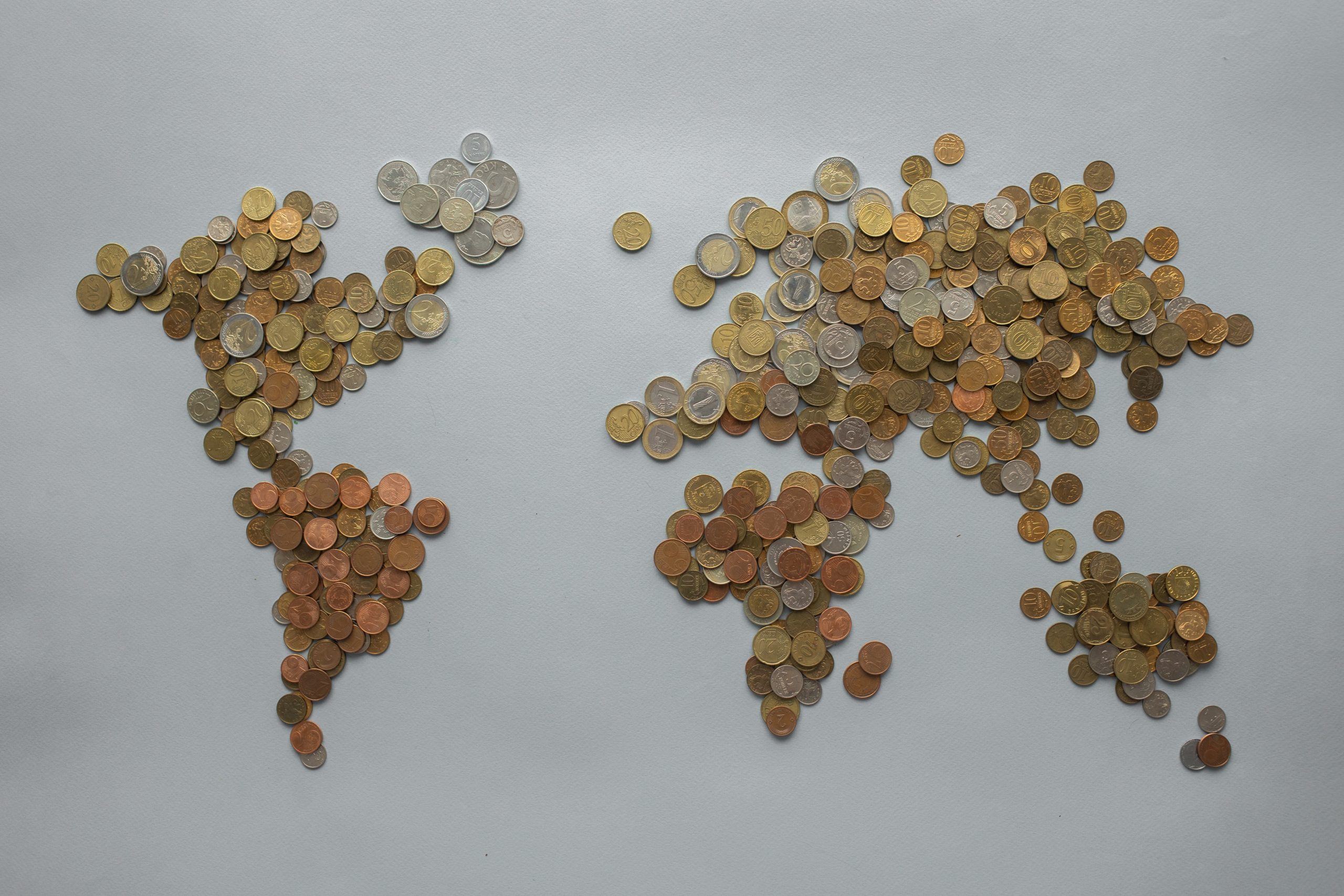 Coins assembled in the shapes of the continents of the world