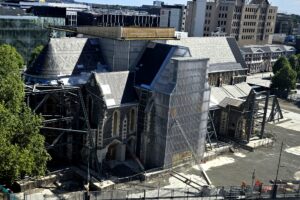 Photo from above of Christchurch Cathedral in disrepair, with scaffolding and other construction equipment